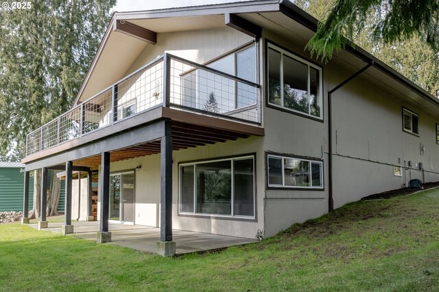 rear view of property with a deck and a yard