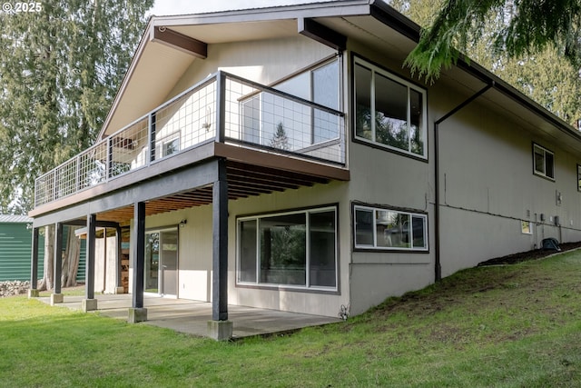 rear view of property with a patio area and a lawn