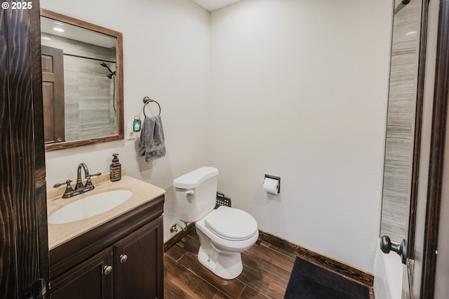 full bath featuring baseboards, vanity, toilet, and wood tiled floor