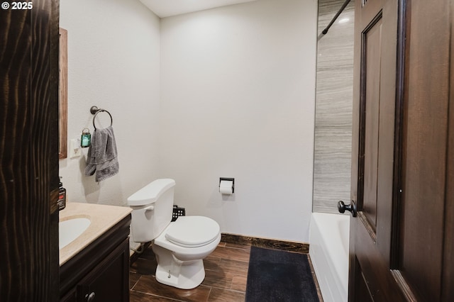 full bath featuring wood finished floors, vanity, toilet, and baseboards