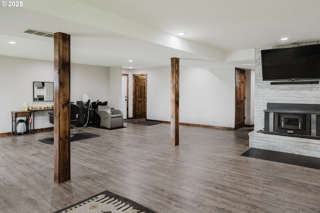 finished basement featuring recessed lighting, wood finished floors, visible vents, and baseboards