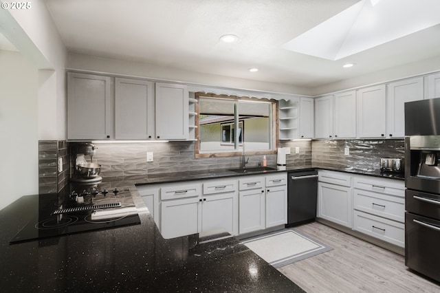 kitchen with light wood finished floors, open shelves, backsplash, stainless steel fridge, and dishwasher