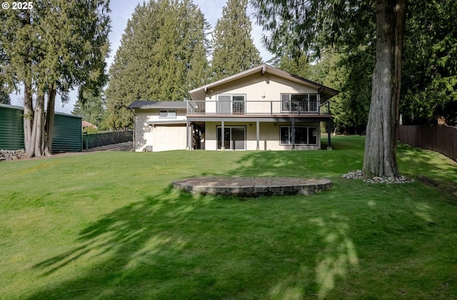 back of house with a lawn, a deck, and fence