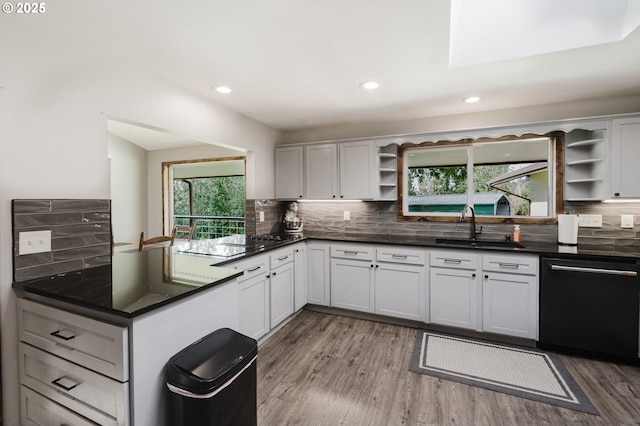 kitchen with open shelves, dark countertops, backsplash, a sink, and dishwasher