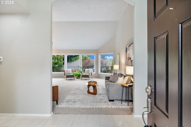 living room featuring high vaulted ceiling and light colored carpet