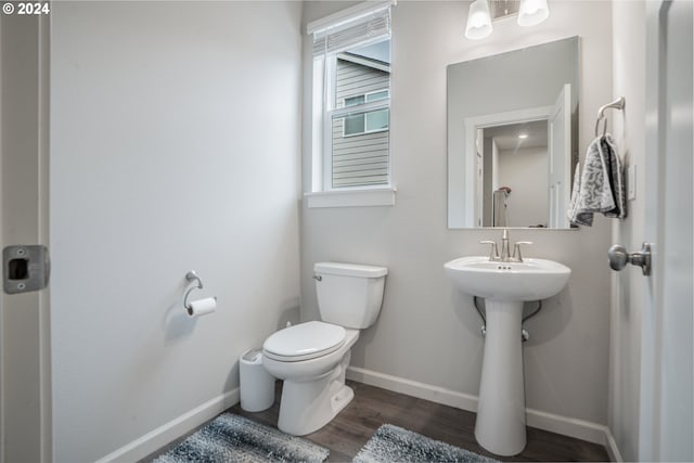 bathroom featuring toilet and wood-type flooring