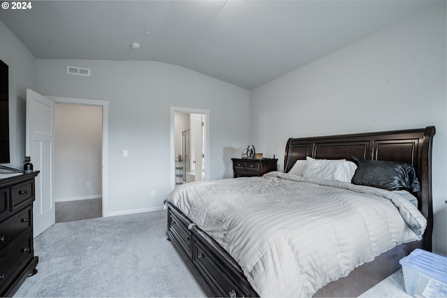 carpeted bedroom with lofted ceiling