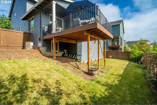 rear view of house featuring central air condition unit, a yard, and a deck