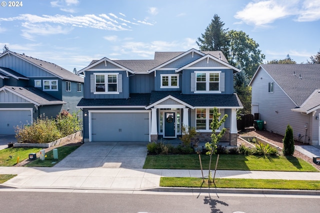 craftsman house with a garage and a front lawn