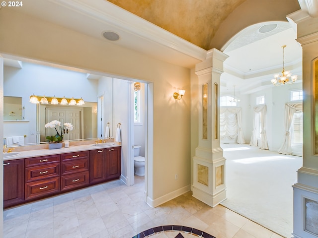 bathroom featuring vanity, toilet, ornate columns, and tile patterned flooring