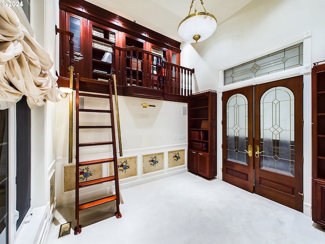 entryway featuring carpet floors and french doors