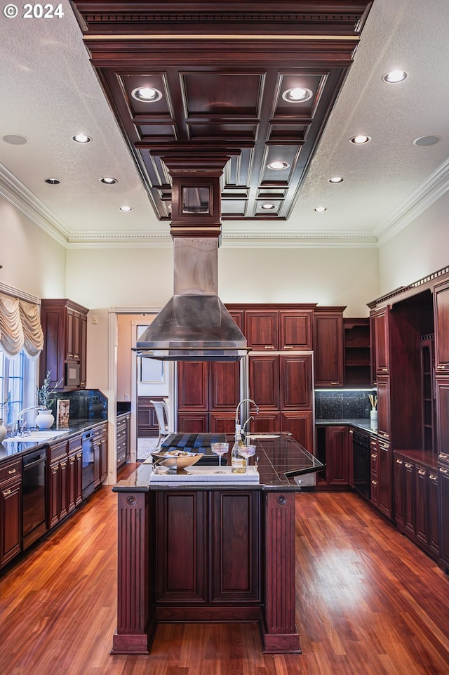 kitchen with black dishwasher, hardwood / wood-style floors, island exhaust hood, a kitchen island with sink, and crown molding