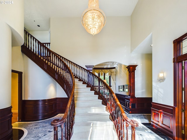 foyer featuring a high ceiling and an inviting chandelier