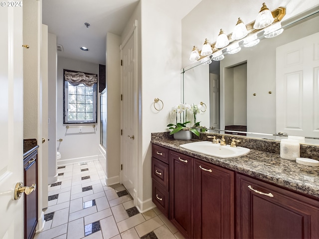 bathroom featuring tile patterned floors, toilet, a shower with door, and vanity