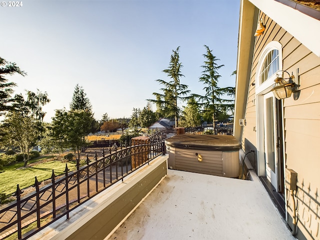 balcony with a patio area and a hot tub