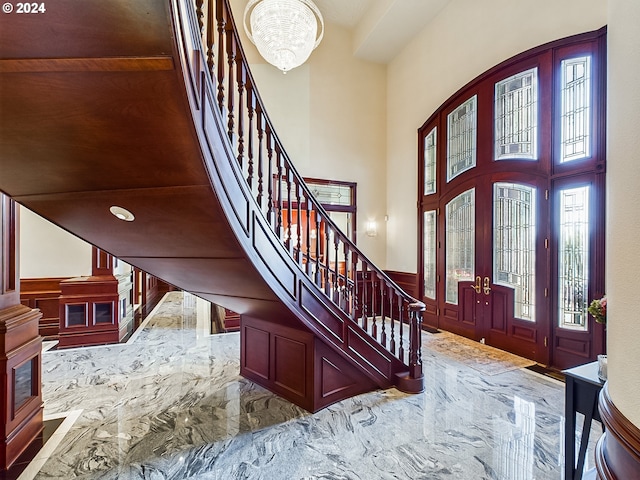 20417 SW Inglis Dr, Beaverton, OR 97007 - foyer with stairs, a high ceiling, a chandelier, marble finish flooring, and a wainscoted wall