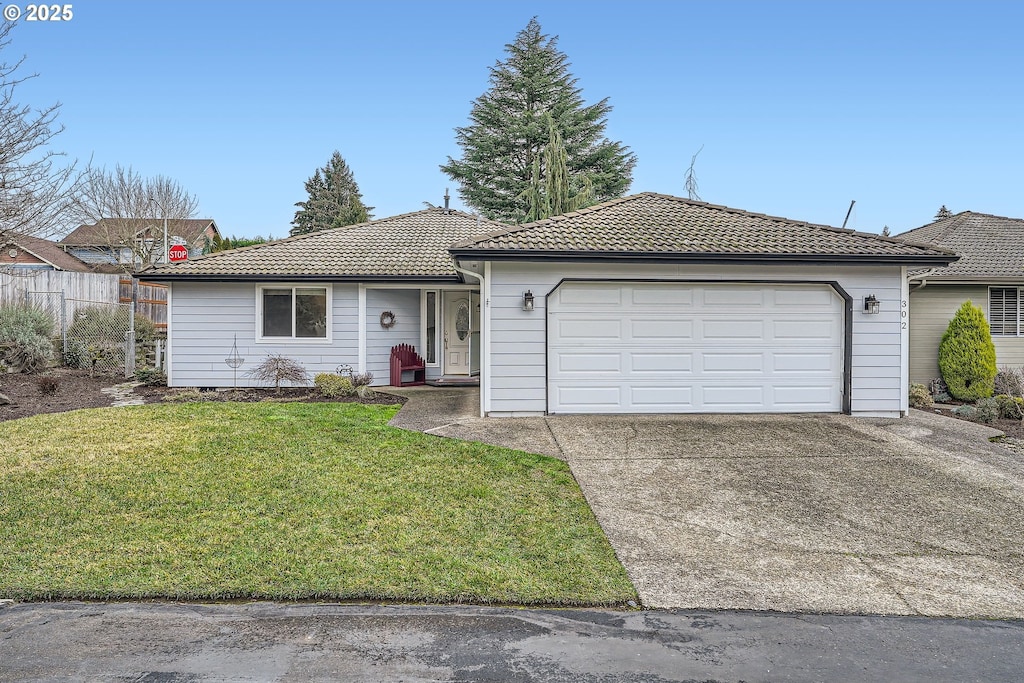 ranch-style house with a front lawn and a garage