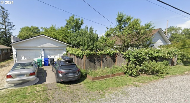 exterior space with an outbuilding and a garage