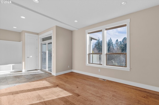 unfurnished room with light wood-type flooring