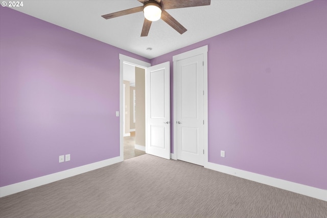 unfurnished bedroom featuring ceiling fan and light carpet