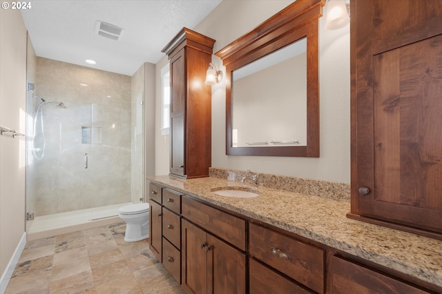 bathroom featuring vanity, toilet, and walk in shower