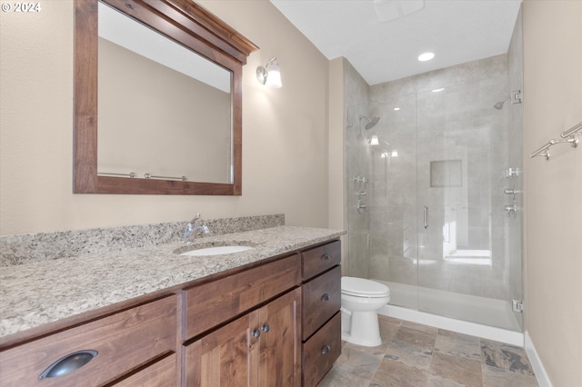 bathroom with vanity, an enclosed shower, and toilet