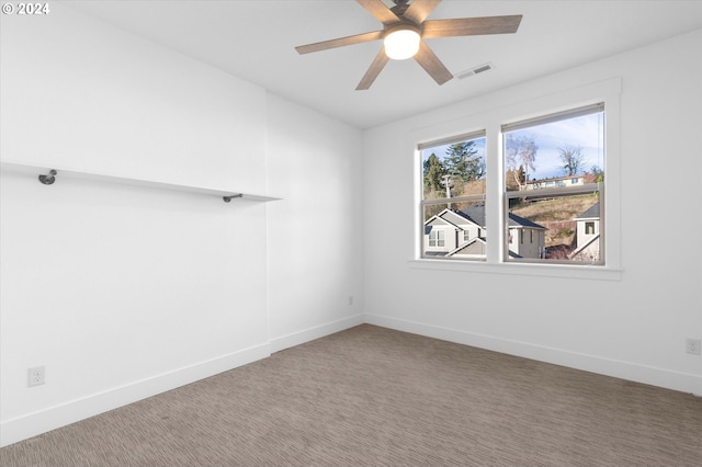 carpeted empty room featuring ceiling fan