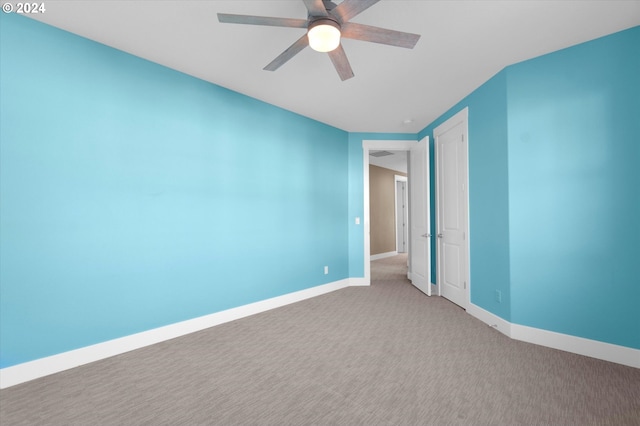 unfurnished room with ceiling fan and light colored carpet