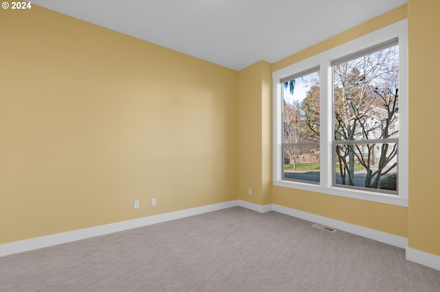 carpeted empty room featuring a healthy amount of sunlight