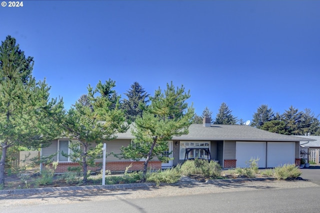 486 Ridge Dr, Gearhart, OR 97138 - ranch-style house with a chimney and brick siding