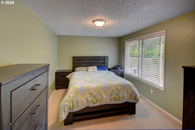 carpeted bedroom featuring a textured ceiling