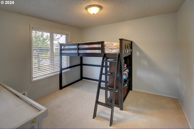 carpeted bedroom with a textured ceiling