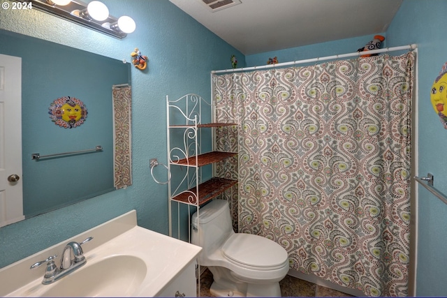 486 Ridge Dr, Gearhart, OR 97138 - bathroom featuring vanity, toilet, a textured wall, visible vents, and curtained shower