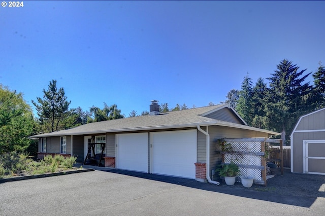 486 Ridge Dr, Gearhart, OR 97138 - ranch-style home with brick siding, driveway, a shed, and an attached garage
