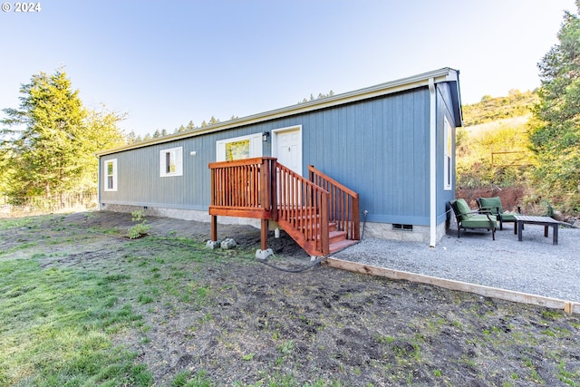 rear view of property featuring a yard and crawl space