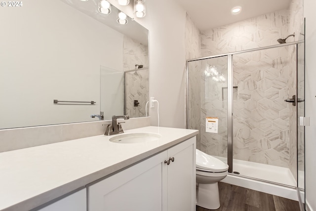 bathroom featuring vanity, hardwood / wood-style flooring, toilet, and an enclosed shower