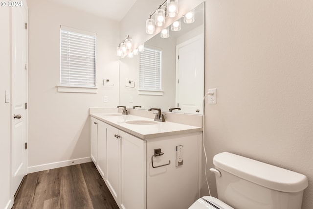 bathroom featuring vanity, wood-type flooring, and toilet