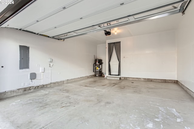 garage featuring secured water heater, electric panel, and a garage door opener