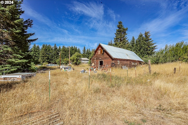 view of yard with a barn and an outdoor structure