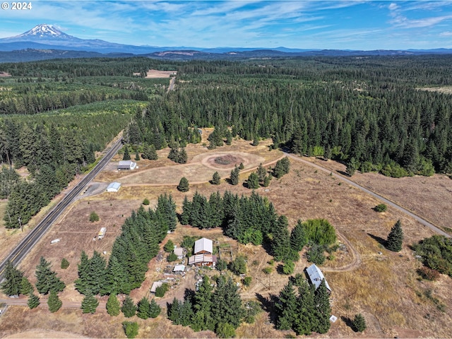 drone / aerial view featuring a view of trees and a mountain view