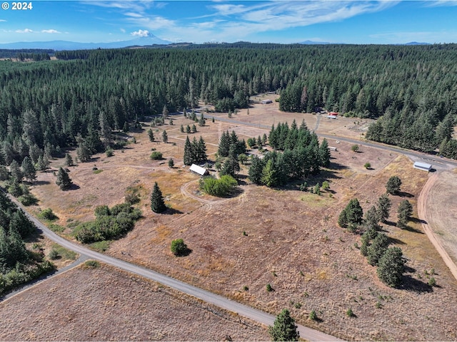 birds eye view of property with a forest view and a mountain view