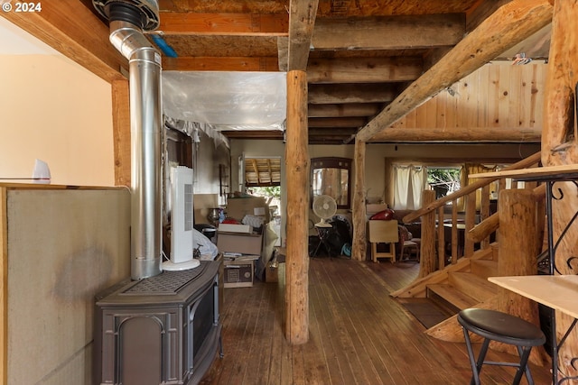 basement featuring a wealth of natural light and dark wood-type flooring