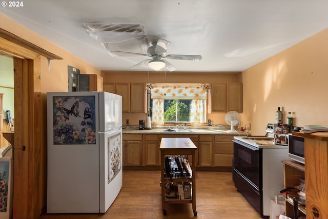 kitchen featuring electric range, light wood-style flooring, freestanding refrigerator, light countertops, and ceiling fan