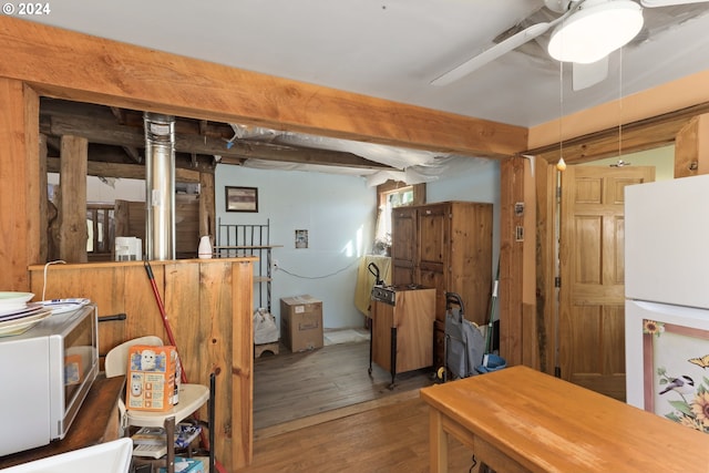 interior space featuring wood-type flooring and ceiling fan