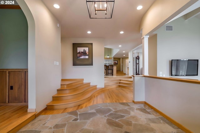 hall featuring visible vents, baseboards, light wood-style flooring, and recessed lighting