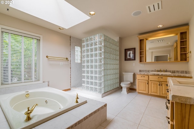 full bath featuring a skylight, visible vents, toilet, tile patterned floors, and vanity