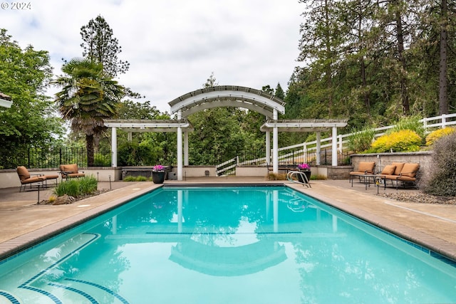 view of swimming pool featuring a fenced in pool, fence, a pergola, and a patio