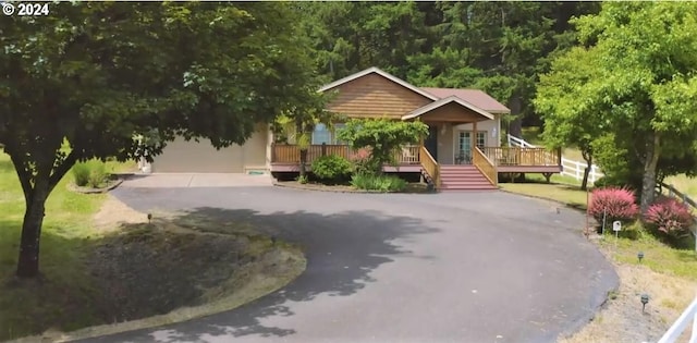 view of front of house with driveway and a wooden deck