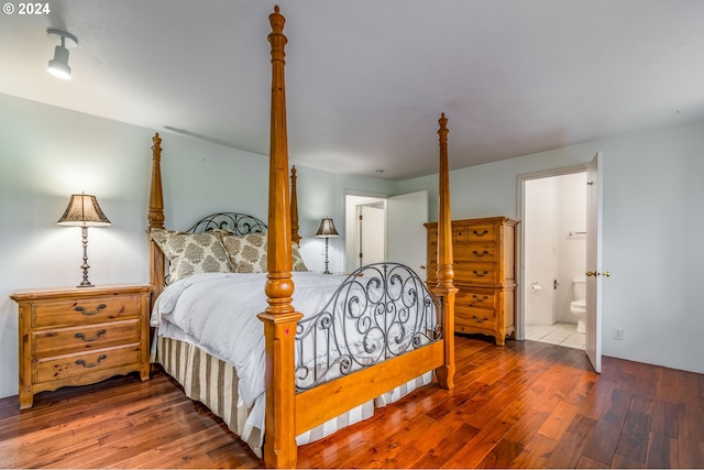 bedroom featuring wood-type flooring and connected bathroom