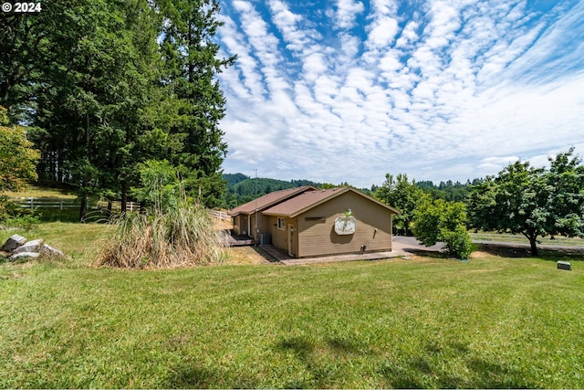 view of side of home with a lawn